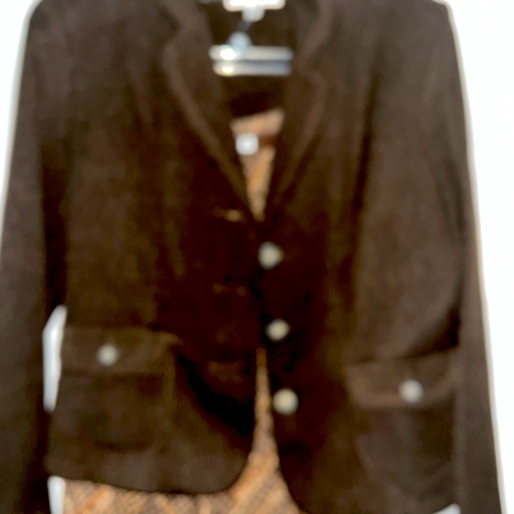 A-line brown and tan elastic waistband middi skirt and brown long sleeve jacket.